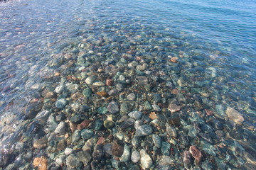 pebbles on the seabed transparent water