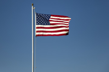 American flag on the blue sky