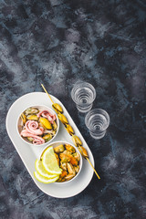 Sea cocktail - mussels, calamari, octopus and alcohol drink on dark concrete background.  Top view.