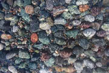 pebbles on the seabed transparent water