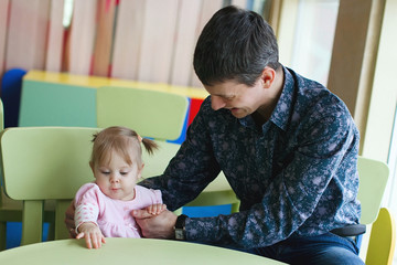 Handsome father and his cute little daughter spending time together