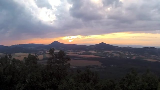 Sunset over Milesovka hill when viewed from Lovos hill in  PLA Czech central mountains