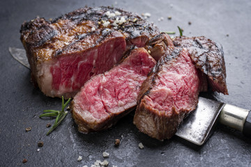 Barbecue aged wagyu rib eye steak as close-up on slate