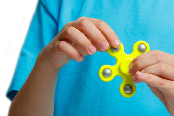kid hand holding popular fidget spinner toy