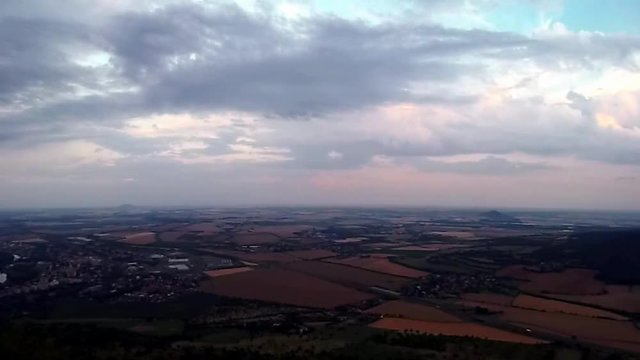 View from Lovos hill to czech highway D8 leading from Prague to Germany near Vchynice village with castle ruins Hazmburk in PLA Czech central mountains at sunset