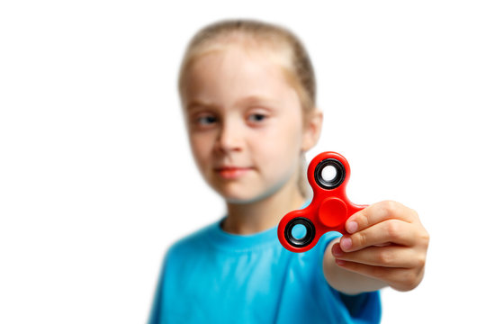 Little girl play with modern finger spinner.