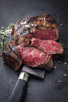Barbecue aged wagyu rib eye steak as close-up on slate