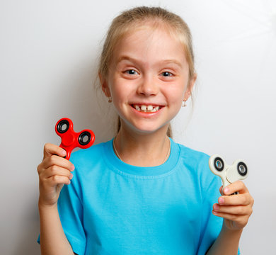 Little girl playing with fidget spinner