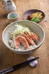 Traditional Japanese hokkaidon thinly sliced salmon donburi as close-up in a bowl