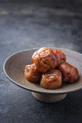 Traditional Japanese umeboshi as close-up in a bowl
