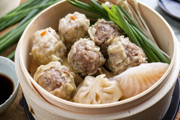 Traditional Chinese dim sum as close-up on bamboo steamer