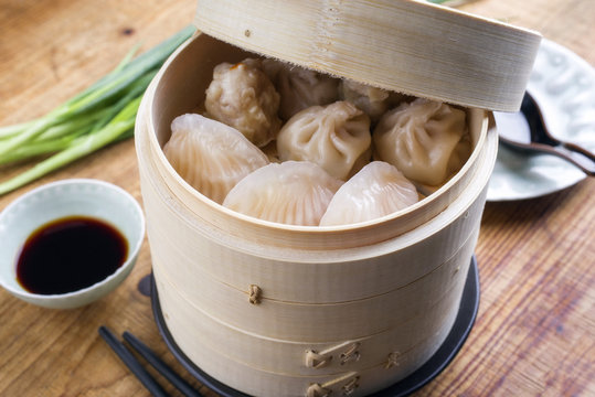Traditional Chinese dim sum as close-up on bamboo steamer