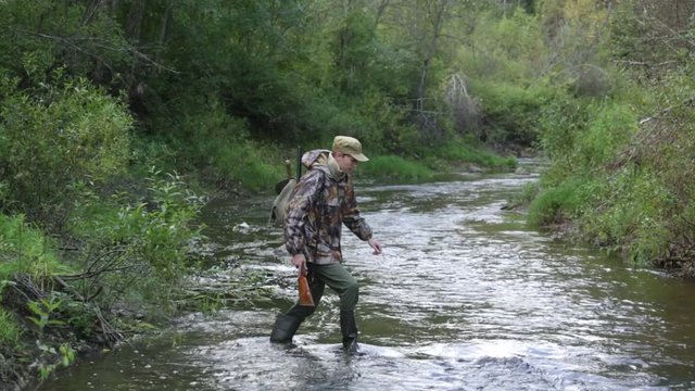Hunter crosses a rough river
