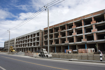 Asian thai workers and local machinery working builder new building at construction site high-rise building