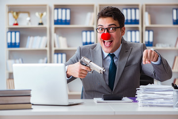 Clown businessman working in the office angry frustrated with a 