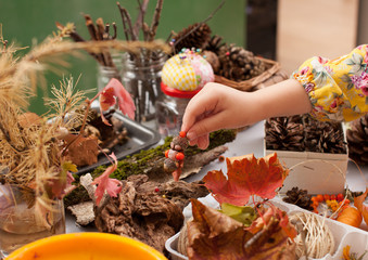 Girl playing with a doll from natural materials