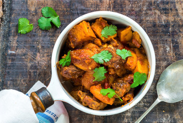 Maroccan lamb tajine garnished with fresh coriander leaves