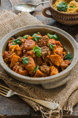 Maroccan lamb tajine with couscous garnished with fresh coriander leaves