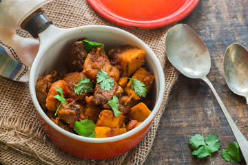 Maroccan lamb tajine garnished with fresh coriander leaves