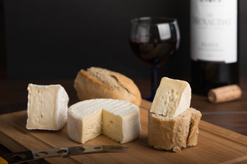 variety of french cheese with a glass of wine and bottle