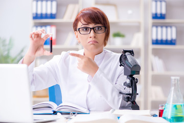 Female scientist researcher conducting an experiment in a labora