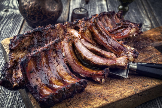 Barbecue pork spare ribs as top view on an old cutting board