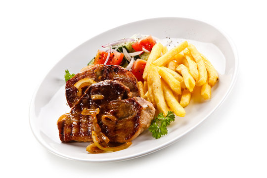 Grilled beefsteak with french fries on white background 