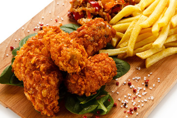 Fried chicken nuggets, chips and vegetables 