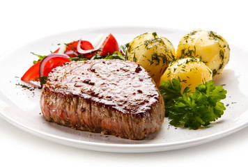 Grilled steak with vegetables on white background 