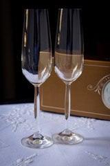Empty crystal glasses on embroidered tablecloth.