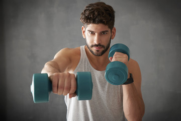 Young man lifting a dumbbell