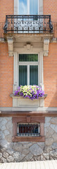 Fototapeta na wymiar Old window and flowers at an old building