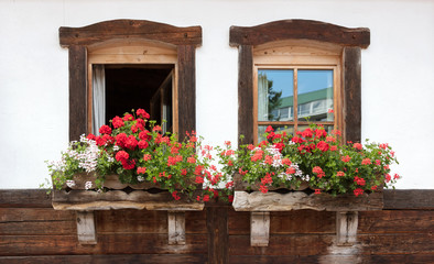 Fototapeta na wymiar Old window and flowers at an old building