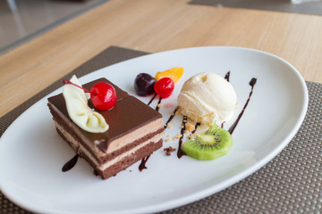 chocolate layer cake and vanilla ice cream with fresh fruit and cherry