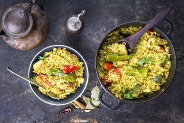 Fotobehang Indian vegetable biryani with sweet pepers and zucchini as close-up in a frying pan © HLPhoto