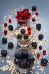 granola, oatmeal and fresh juicy berries cranberries and blueberries, concept of vegetarian healthy eating