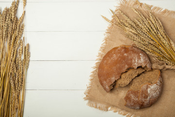 white flour decoration on table bread of brown color in brown sack and sunset