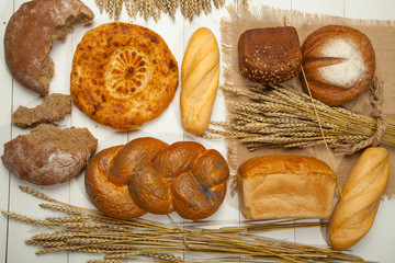 Assortment of bread on a white wooden background