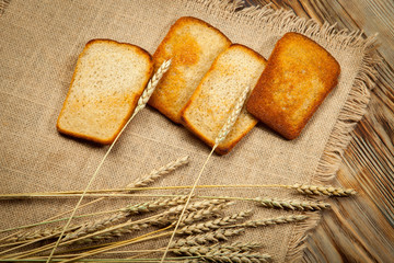 Toast bread in a wicker plate on wooden background. Top view