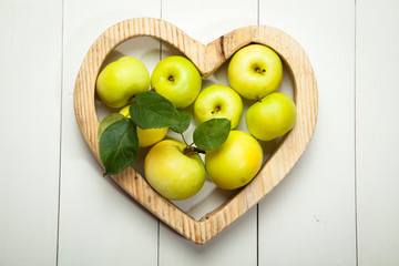 Fresh apples on a white wooden background