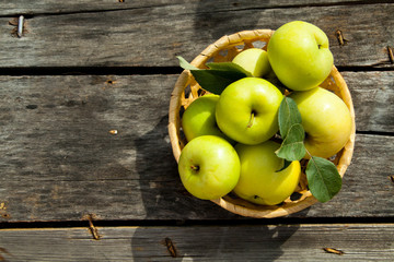Green apples on a rustic wooden background