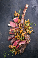 Barbecue dry aged wagyu tomahawk steak sliced with as close-up on old wooden board