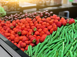 Strawberry, peas, cherries on the counter in the store