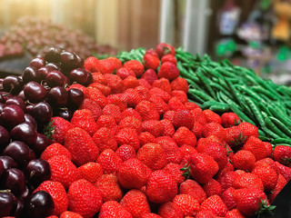 Strawberry, peas, cherries on the counter in the store