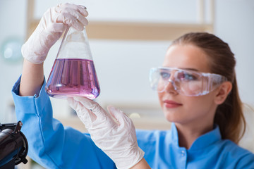 Female scientist researcher conducting an experiment in a labora