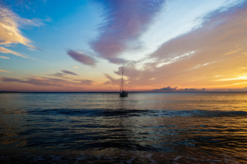 Sailing boath during sunrise on an early morning at the Solanzara beach on the island of corsica. © Dennis Wegewijs