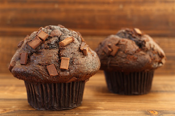 Chocolate chip muffins on wood in natural light