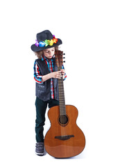 Funny little boy holds a guitar.Cute boy stands and plays the guitar. White background.