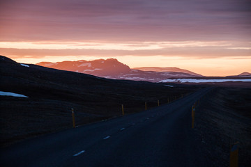 Fototapeta na wymiar A drive with a breathtaking sunset at midnight 