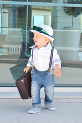 Baby traveler with a suitcase